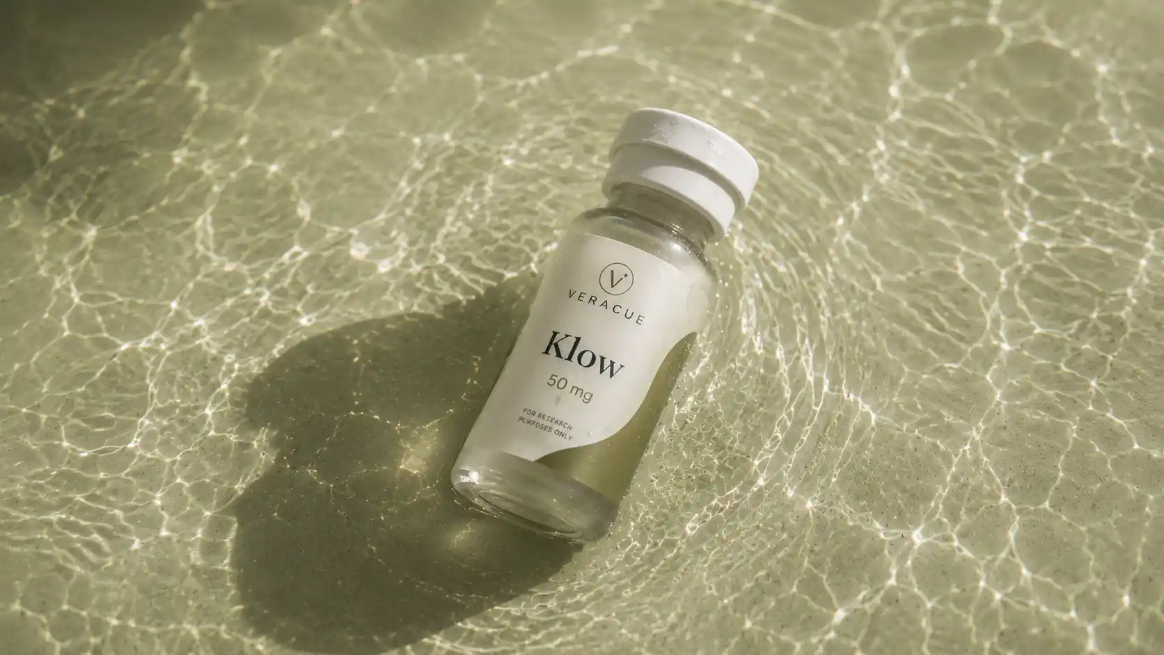 Veracue research peptide vial resting on rippling pool water
